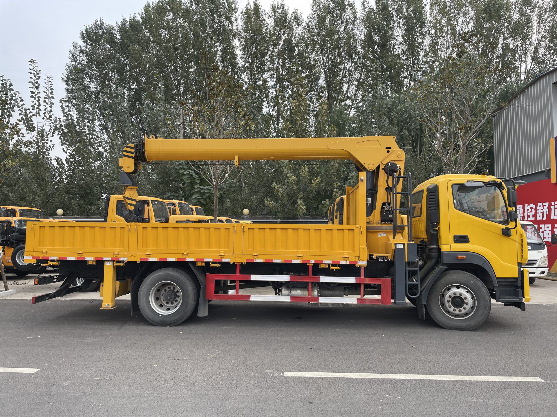 Professional loader crane maintenance and hydraulic system inspection.