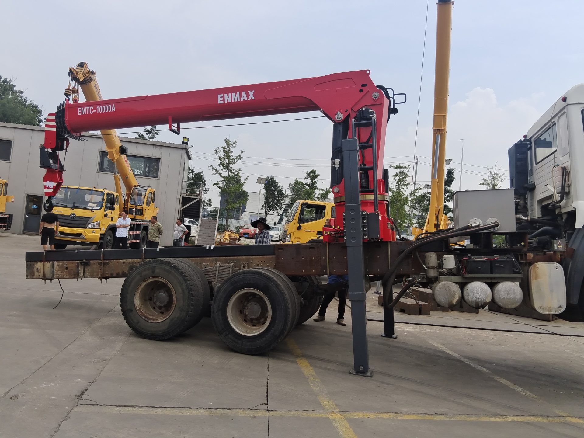 Professional loader crane maintenance and hydraulic system inspection.